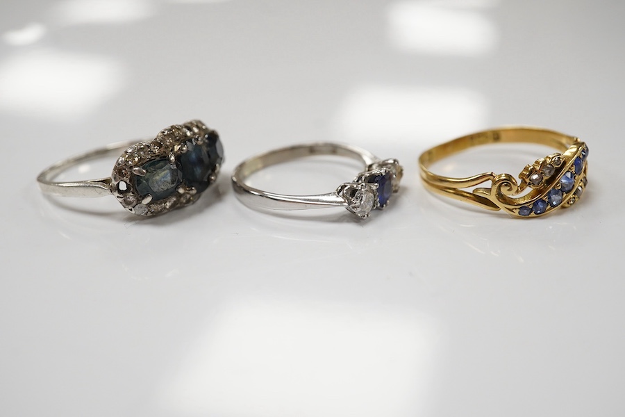 An 18ct white metal, sapphire and diamond set three stone ring, size L and two other sapphire and diamond rings, one late Victorian, gross weight 8.5 grams. Condition - fair to good